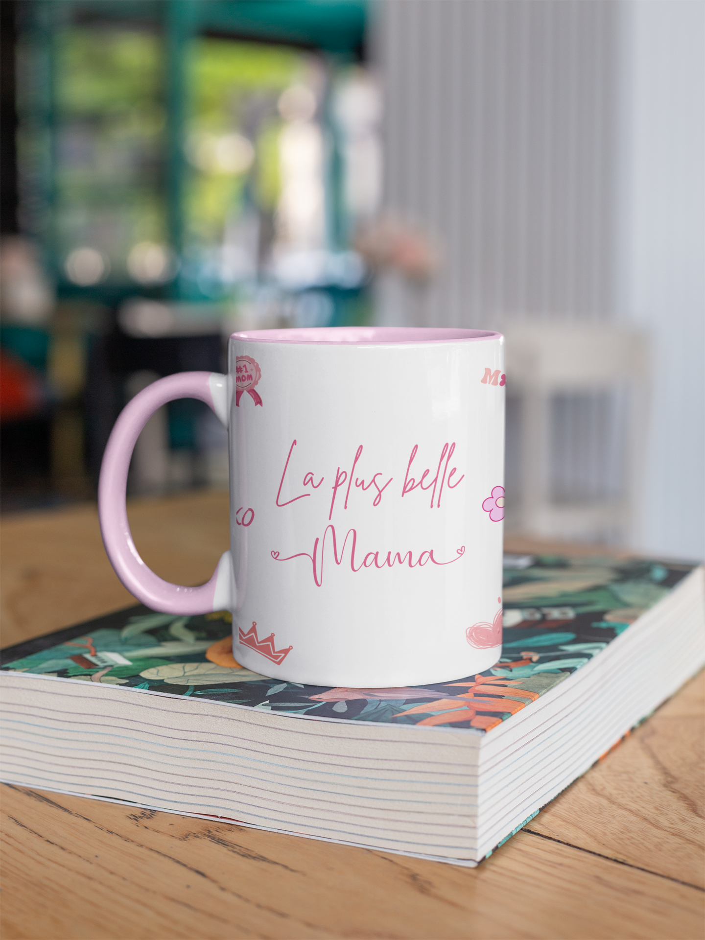 Mug with 'La plus belle Mama' text on a book in a store setting