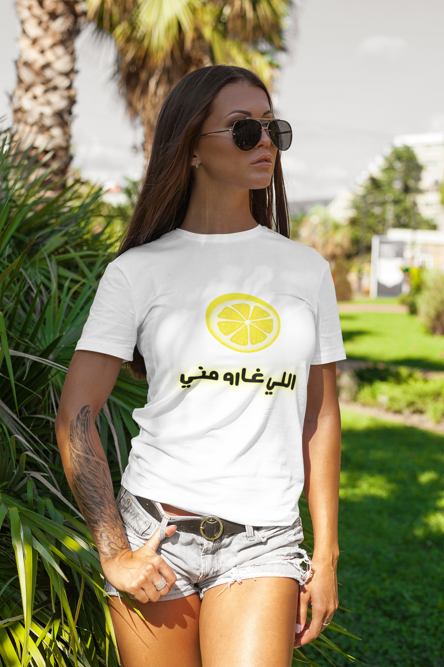 Woman wearing white T-shirt with Arabic text and lemon slice design